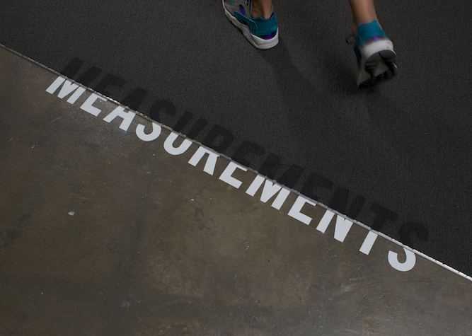 Hand-painted word MEASUREMENTS on an office floor