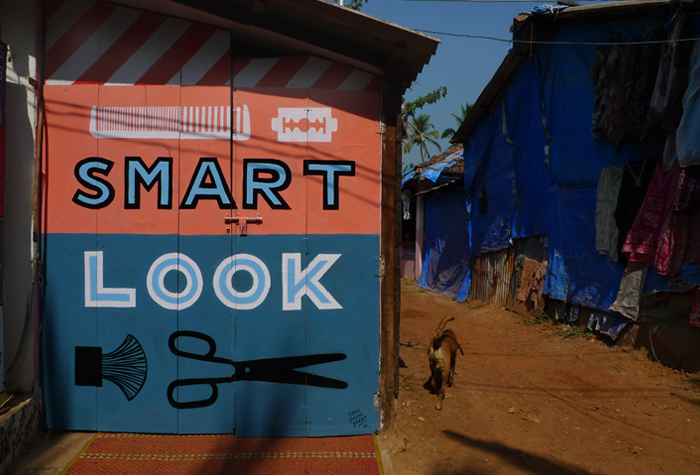 Hand-painted SMART LOOK sign on a blue wall