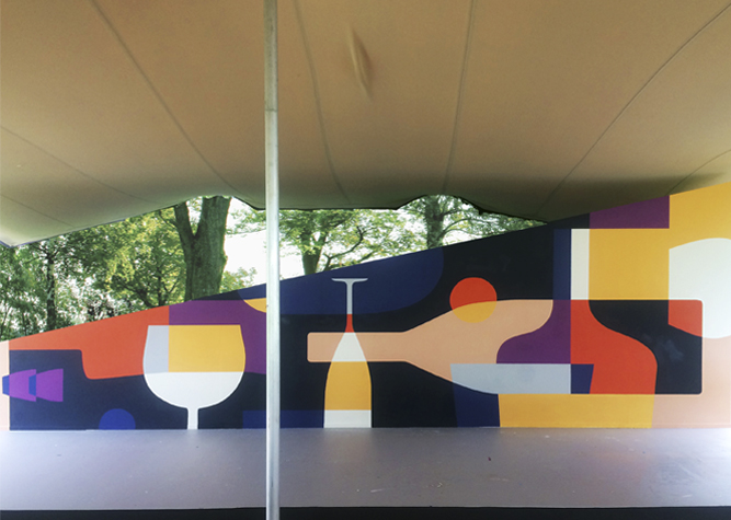 Long wall painting of geometric shapes under a canopy