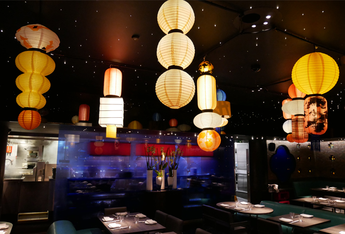 Handmade lanterns hanging above a restaurant bar